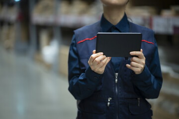 Warehouse worker checking inventory with digital tablet in logistics warehouse