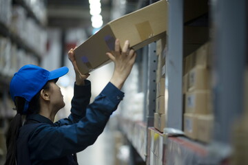 Warehouse worker arranging stock in logistics warehouse