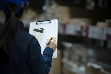 Warehouse worker checking inventory in logistics warehouse