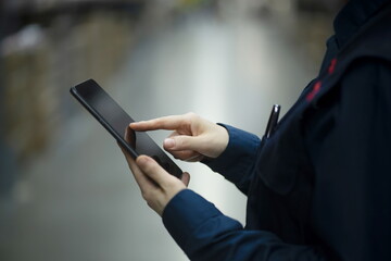 Warehouse worker checking inventory with digital tablet in logistics warehouse	