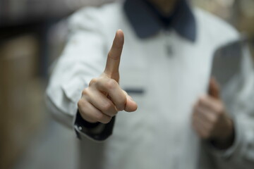 Warehouse worker pointing finger  in logistics warehouse