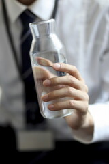  Close up of businessman holding water bottle
