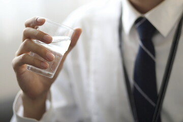 Businessman drinking water in office