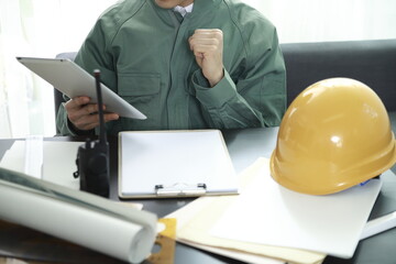 Engineer using digital tablet at desk in office