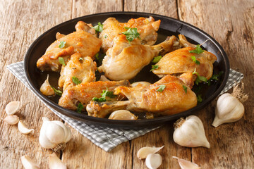 Pollo al Ajillo is a Spanish version of garlic chicken cooked with a garlic and white wine close-up...