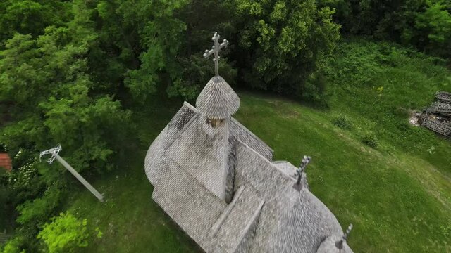 Aerial View of Old Wooden Church by Vitasi Station and Sargan Eight Narrow Gauge Railway, Mokra Gora, Serbia, Drone Shot