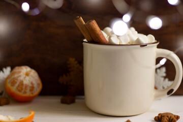 Christmas coffee cup with cinnamon sticks and marshmellow, christmas cookies , christmas lights .Christmas or new year  mock up  on wooden board
