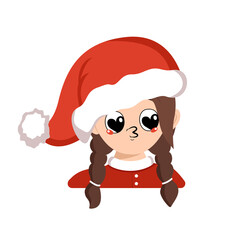 Girl with big heart eyes and kiss lips in red Santa hat. Cute kid with loving face in carnival costume for New Year, Christmas and holiday. Head of adorable child