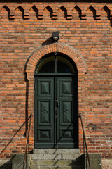 red brick building with closed dark door