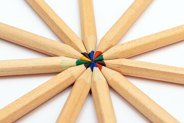 Many different colored pencils.Color pencils in arrange in color wheel colors on white background.