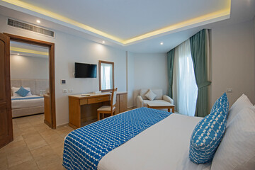 Double bed in family room suite of a luxury hotel
