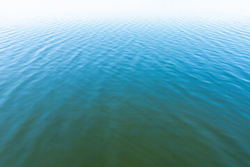 Blue Water Calm Waves Surface as Background.Calm water surface with small ripples.Nice blue water background.