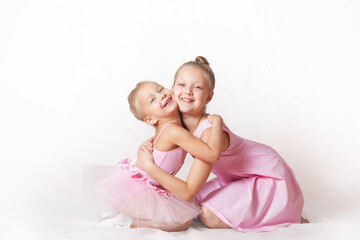 girls - young ballerinas in pink dresses on a light background