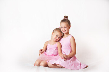 girls - young ballerinas in pink dresses on a light background
