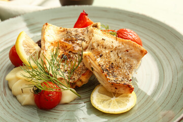 Plate with tasty baked cod fillet, vegetables and mashed potatoes, closeup