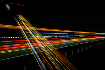 Fototapeta na wymiar Night road lights. Lights of moving cars at night. long exposure red, blue, green