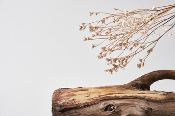 Mock up with wooden log, dry flowers for cosmetics on beige background. presentation of organic...