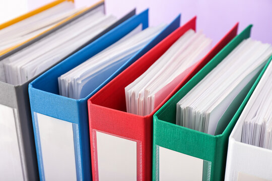 Office folders on color background, closeup