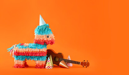 Mexican pinata in shape of horse with party hats and guitar on color background
