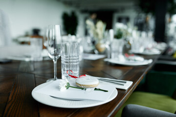 Beautiful decoration of a festive table with crockery and cutlery, decorated with flowers and...