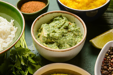 Traditional Indian food and spices on color background