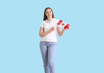 Young woman with Canadian flag on color background