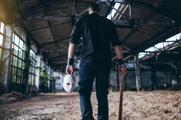 Strange Man with spooky mask and Baseball Bat Walks in Empty Grunge Dark Hall