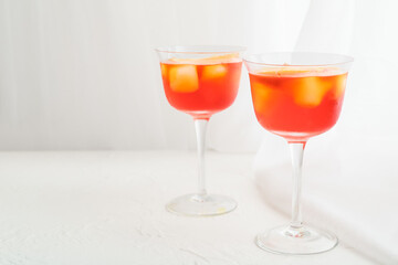 Glasses of Aperol spritz cocktail on light background