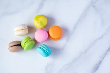 multicolored macarons on marble background