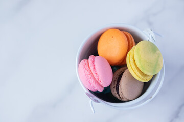 multicolored macarons on marble background copy space