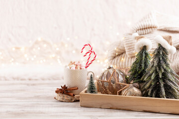 Cup with a hot drink, marshmallow on a table with christmas decorations.