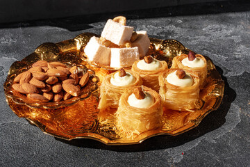 Turkish dessert baklava with nuts on black background