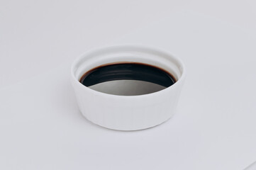 white plate soy sauce on a white background