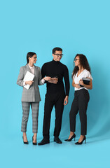 Fototapeta premium Young business people on blue background
