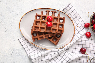 Plate of delicious Chocolate Belgian Waffles with cherry on white background