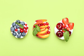 Tasty berry tartlets on color background