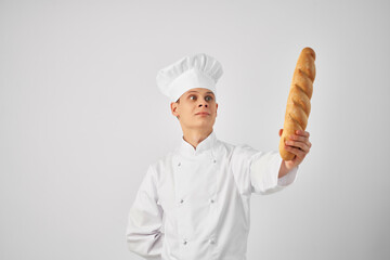 man in chef's clothes with a baguette in his hands baker fresh food