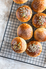Sweet pumpkin buns with cinnamon and anise, light concrete background. Top view.