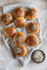 Sweet pumpkin buns with cinnamon and anise, light concrete background. Top view.