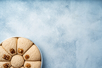 Top view of Turkish desserts on light blue background