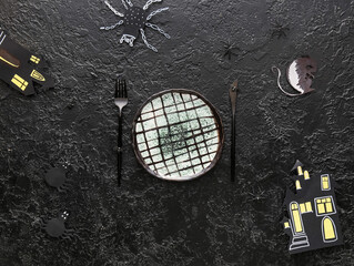 Halloween table setting with decor on black background