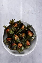 Ayam Goreng Daun Pandan or Thai pandan chicken is fried chicken wrapped in pandan leaves. Thailand authentic food and cuisine