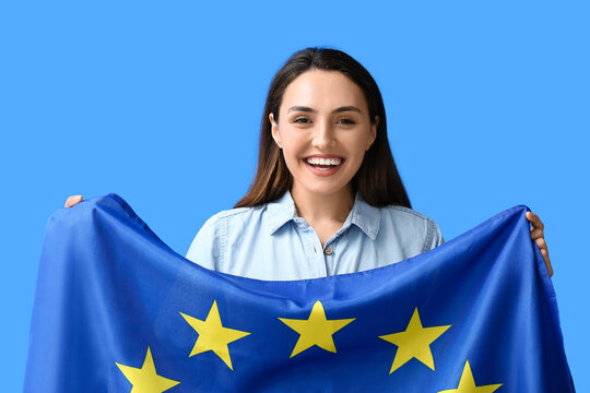 Young woman with flag of European Union on color background