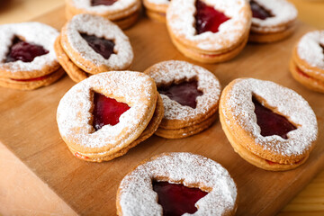 Board with tasty Linzer cookies, closeup