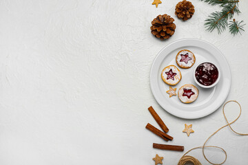 Plate with tasty Linzer cookies and jam on white background