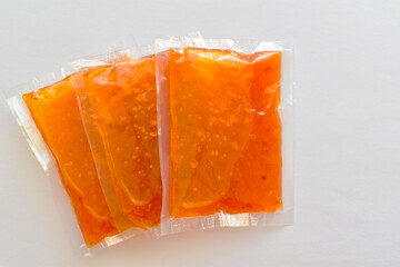 Sweet chilli sauce in vacuum sealed plastic bags with copy space.