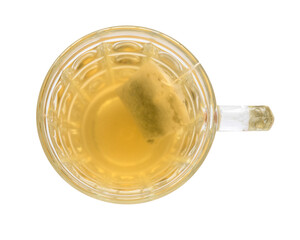 Top view a glass of tea with a tea bag isolated on a white background.