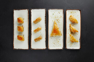 Turkish sweets stacked in a row on rectangular plates