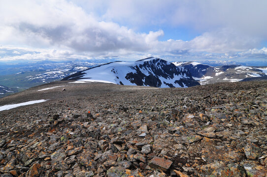 Scenic view on the ascent to Norra Sytertoppen, a mountain peak along the King's Trail, Kungsleden, in the valley Syterskalet between Hemavan and Ammarn&auml;s. Orange trail markers and emergency hut.
