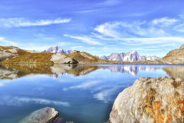 Fototapeta na wymiar In Valle d'Aosta, the small lake of Pietra Rossa, a wonderful jewel in which Mont Blanc and other mountains in the valley are reflected.